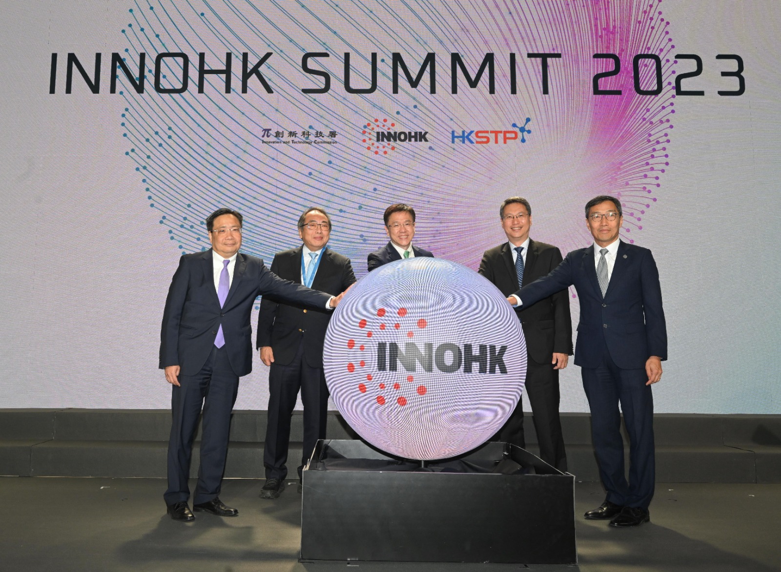 Organised by the Innovation and Technology Commission and the Hong Kong Science and Technology Parks Corporation (HKSTPC), the InnoHK Summit 2023 was held in Hong Kong Science Park today (December 6). Photo shows Secretary for Innovation, Technology and Industry, Professor Sun Dong (centre); the Chairman of the InnoHK Steering Committee, Professor Tsui Lap-chee (second left); the Permanent Secretary for Innovation, Technology and Industry, Mr Eddie Mak (second right); the Commissioner for Innovation and Technology, Mr Ivan Lee (first left); and the Chief Executive Officer of the HKSTPC, Mr Albert Wong (first right), officiating at the opening ceremony.