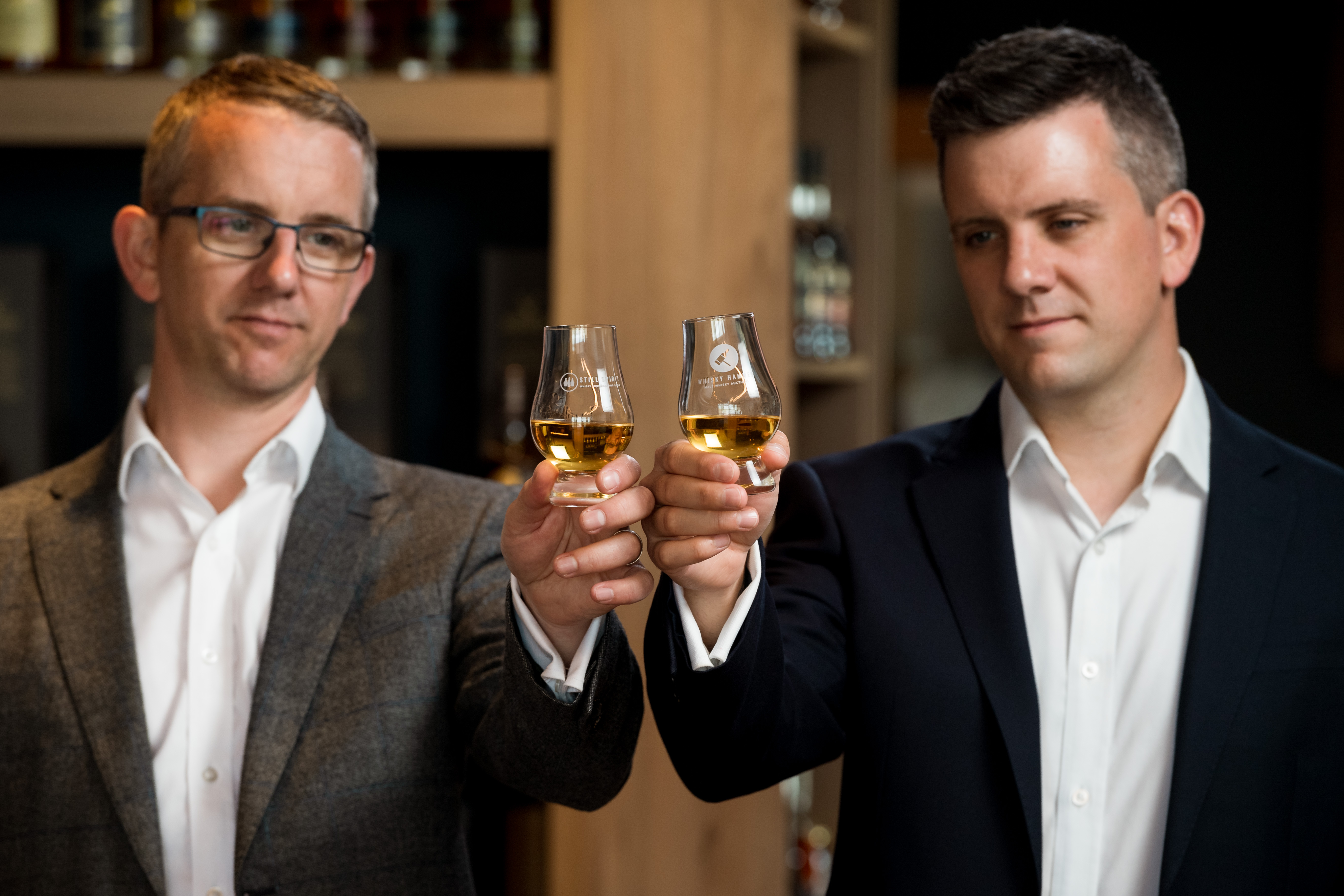 Left to right Craig and Daniel Milne of Whisky Hammer raise a dram to celebrate their 100th online auction