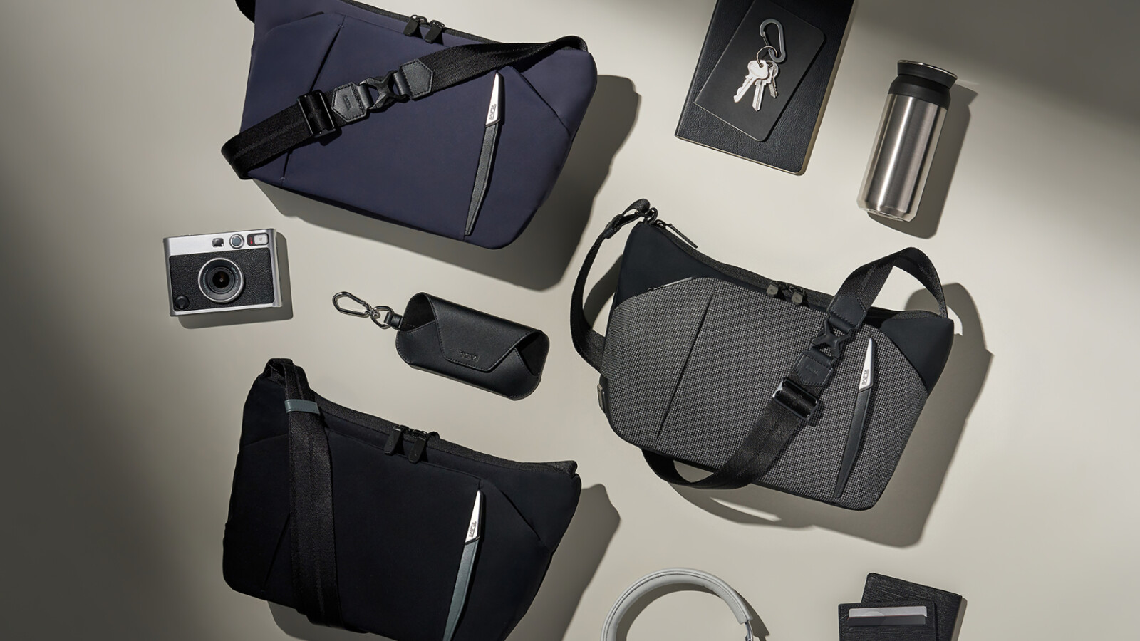 (L to R): The Medium Crossbody in Navy, Black Reflective and Black